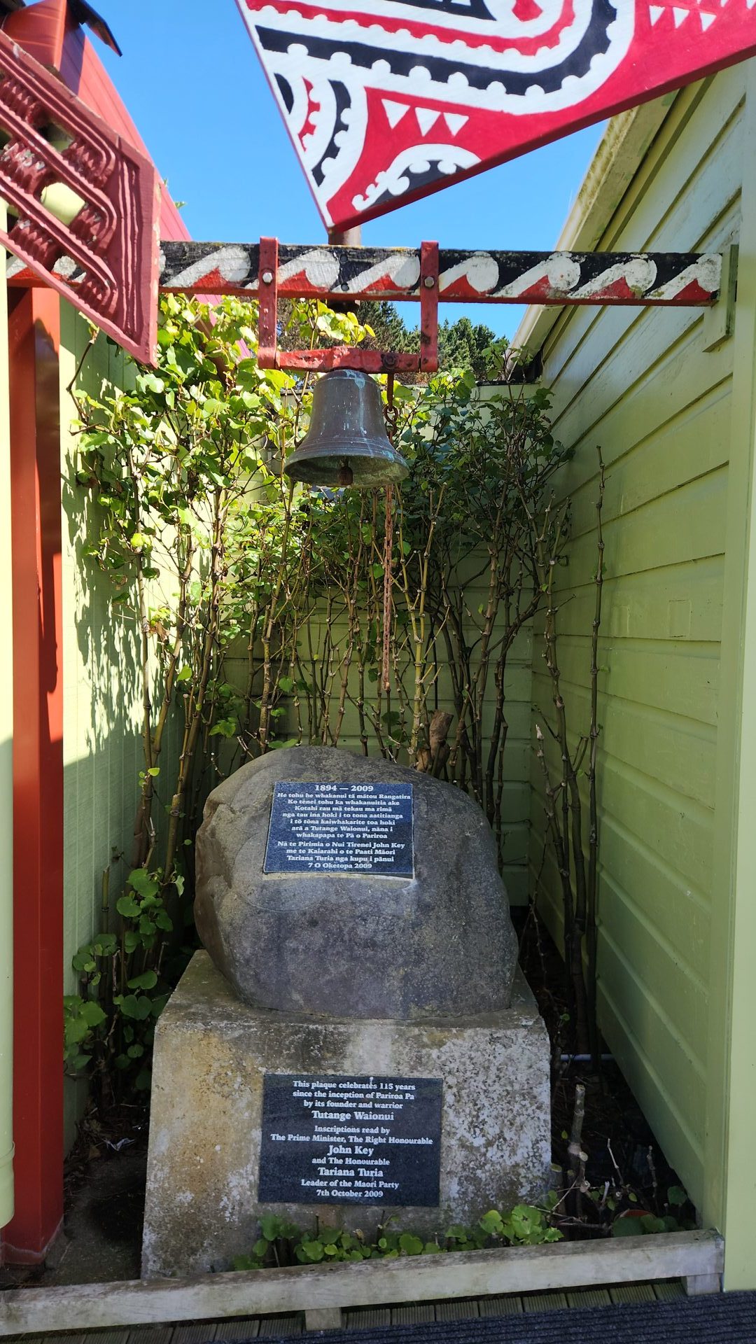 Putoetoe's bell — the pere — above the memorial stone beside her front.