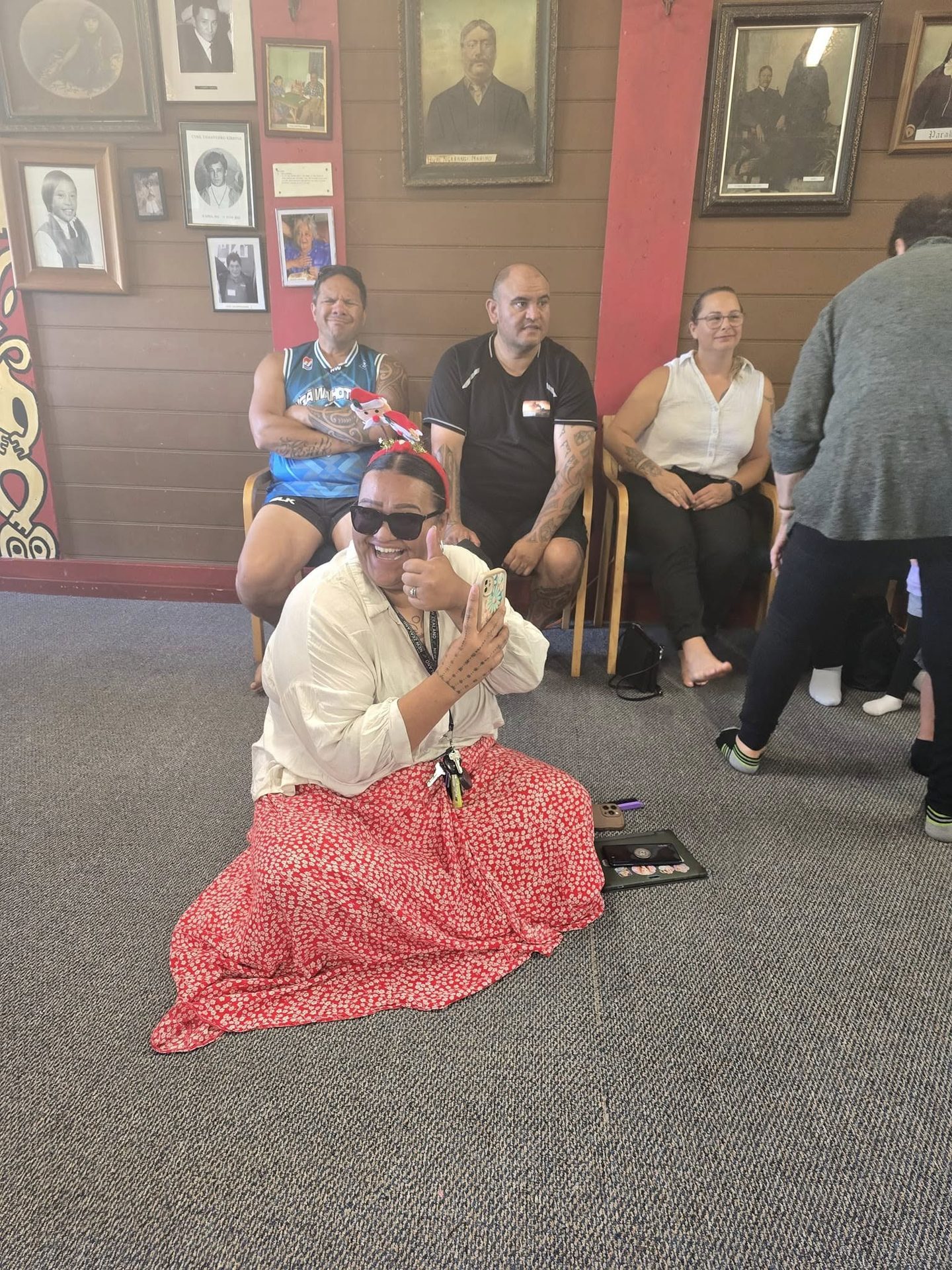 Whānau sitting together, sharing a laugh
