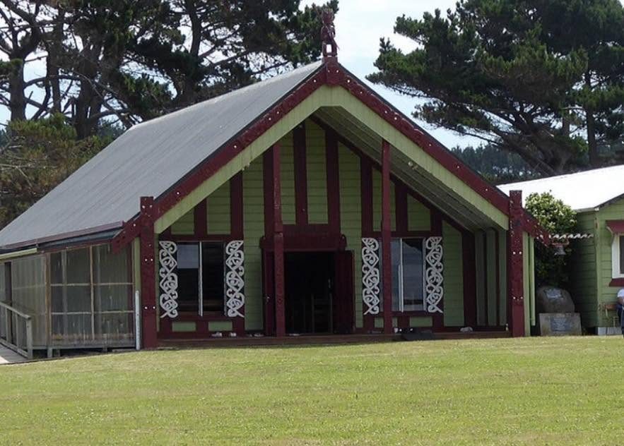 The carved porch and decorative elements of the wharenui.